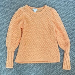 Ces Femme light orange sweater with polka dot detail.